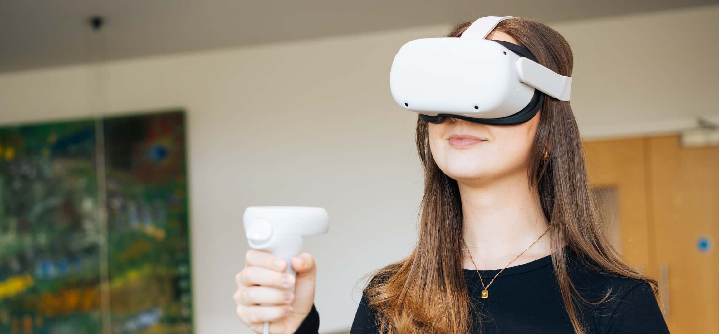 Woman using VR goggles and handset