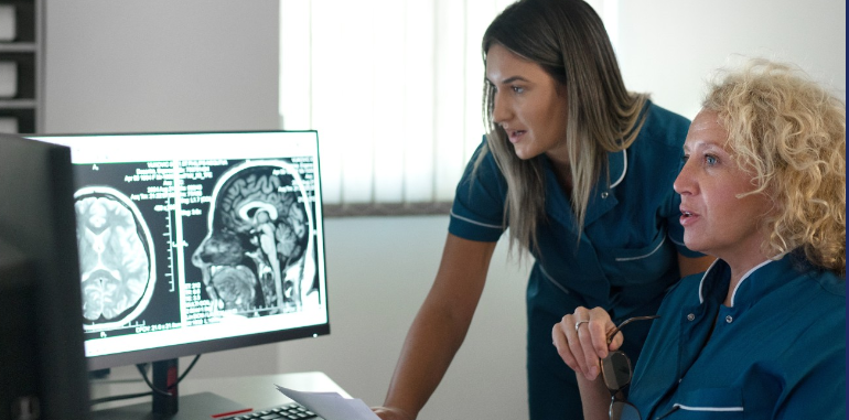 Two people looking at brain scans