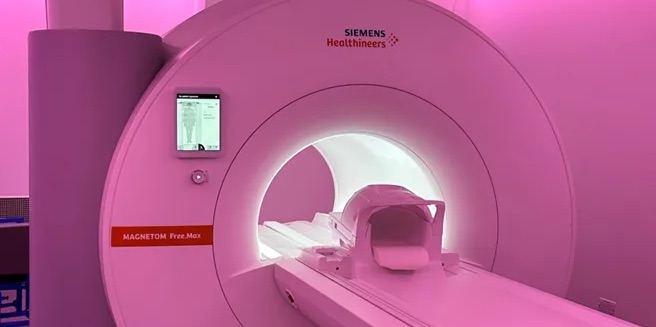 MRI machine in bright pink light