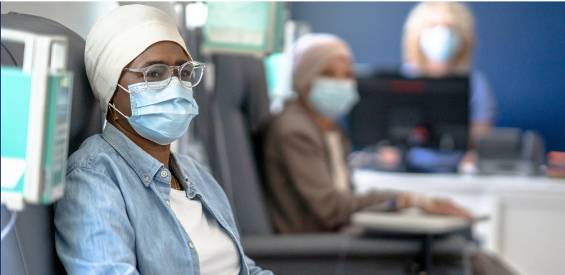 A woman wearing a facemask being monitored