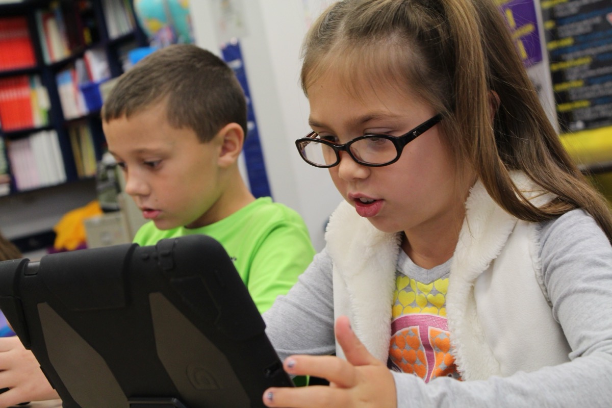Children looking at tablet screens